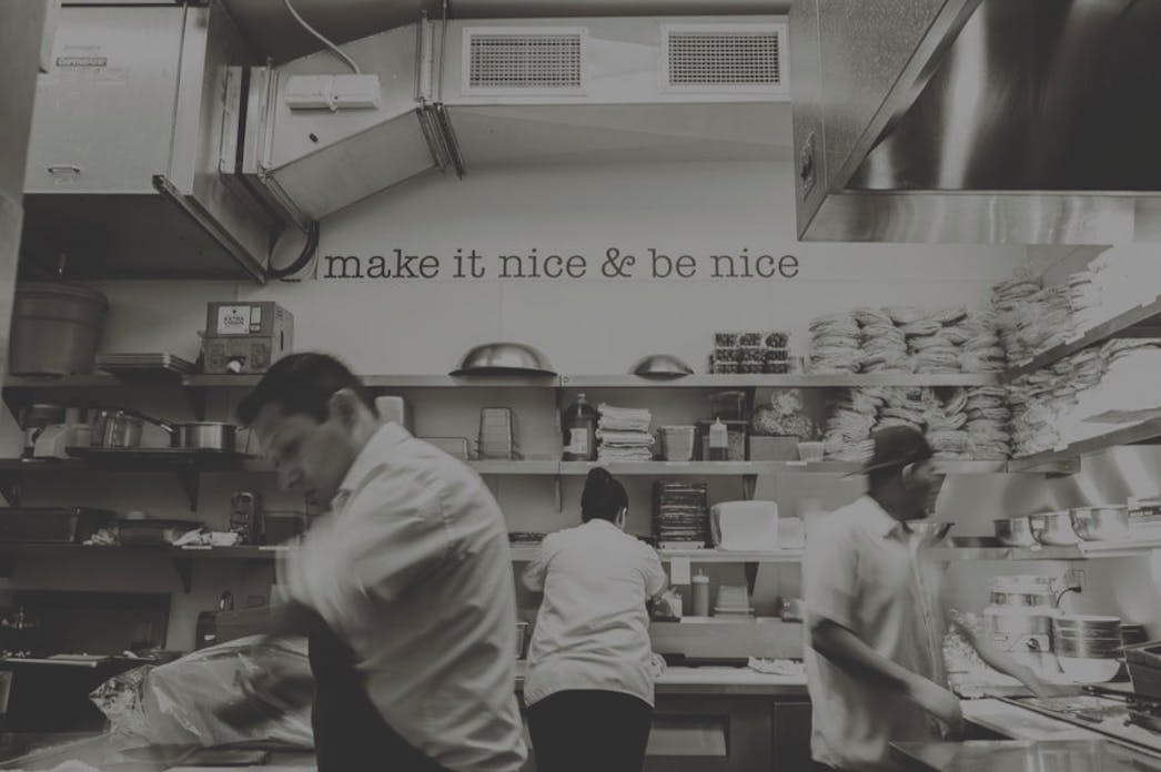 a man cooking in a kitchen preparing food