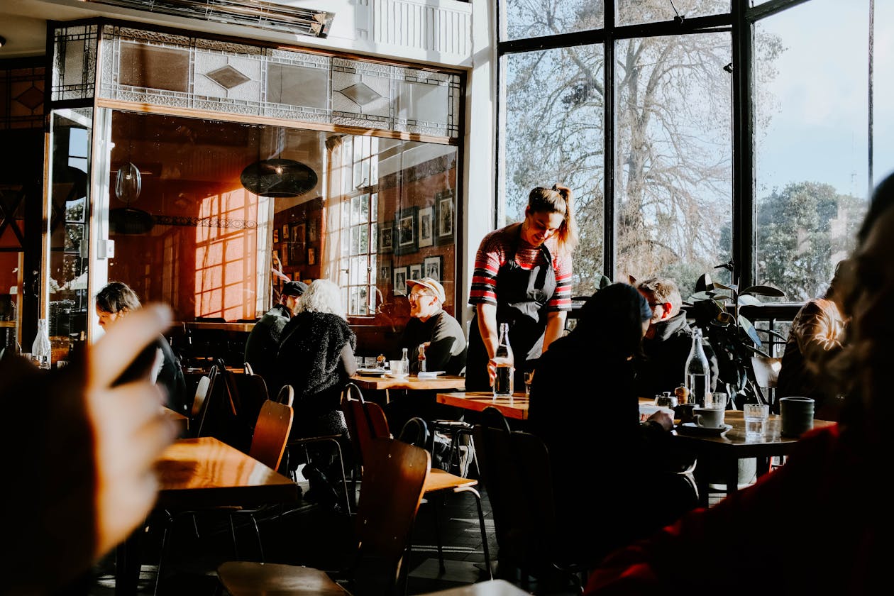 a group of people sitting at a table in front of a window
