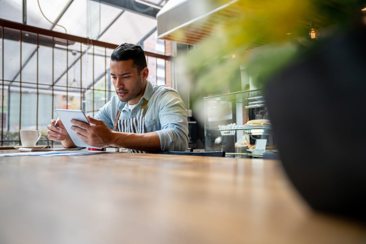 a person sitting at a table using a laptop