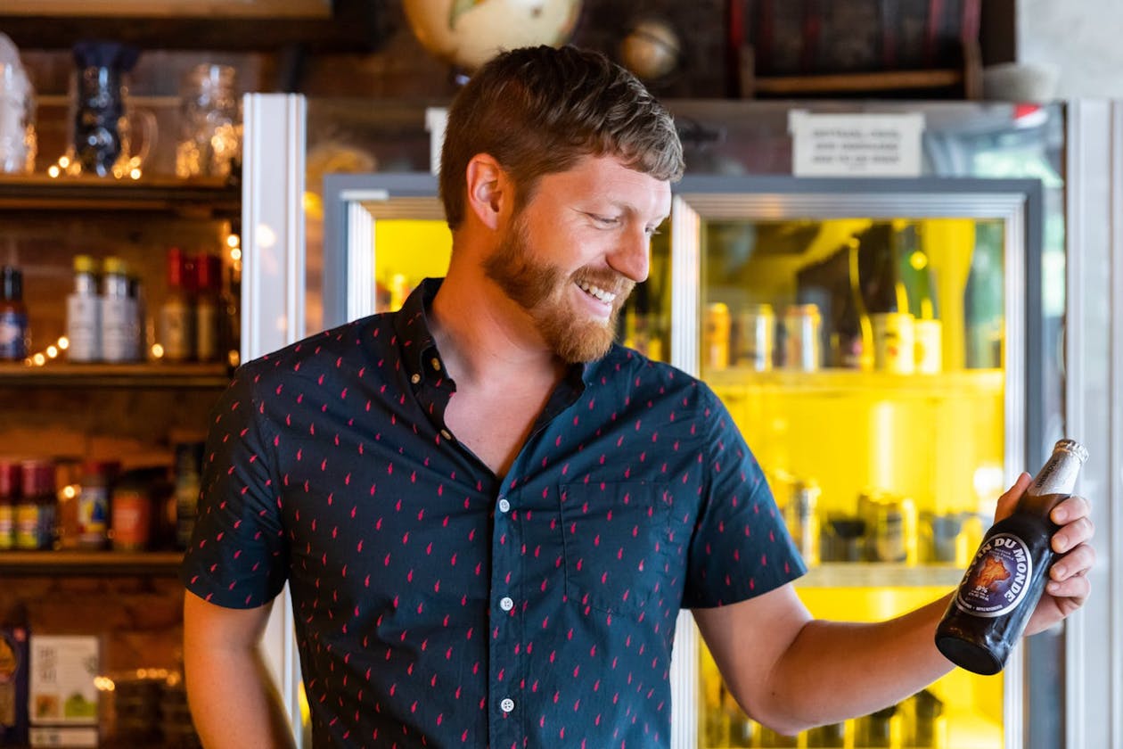 A man standing with a beer in his hand.