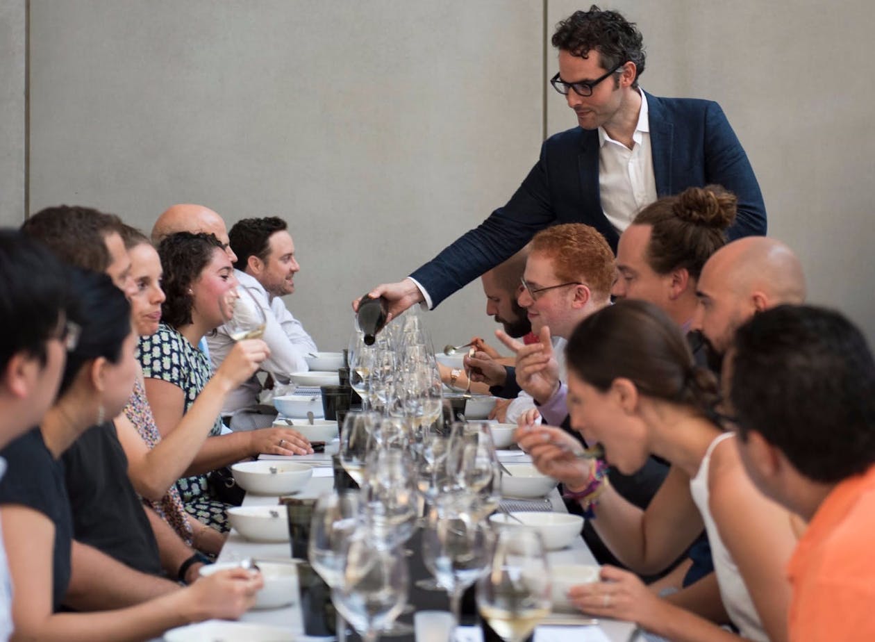 a group of people sitting at a table with wine glasses