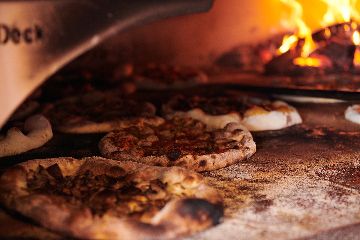 a close up of a slice of pizza sitting on top of a stove