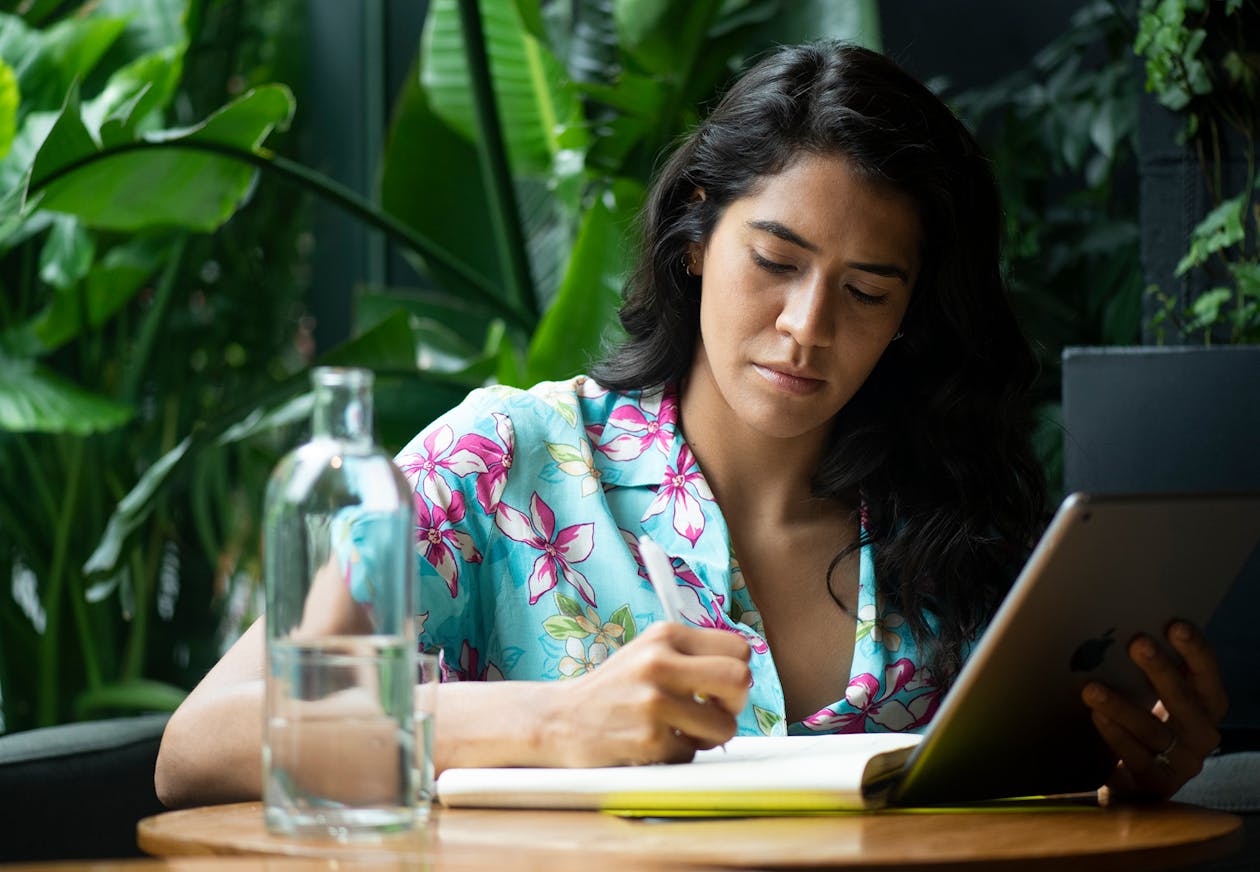 A chef making calculations in her notebook