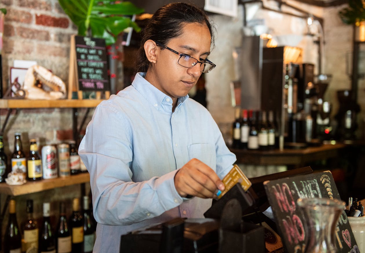 a photo of a takeout man swiping a card