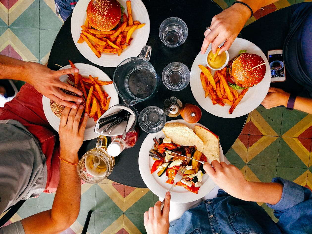 A photo of a table with people eating food.