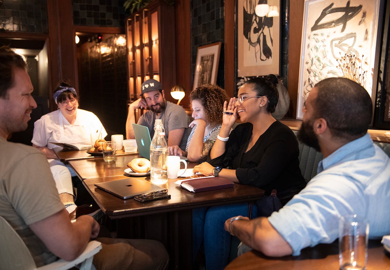 a photo of a restaurant staff meeting