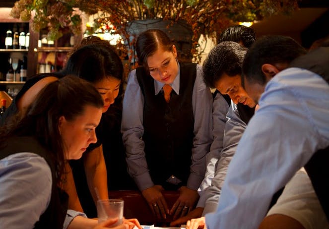 a group of people sitting at a table.