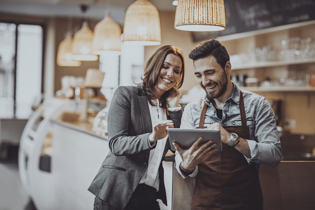 Restaurant owners reading a review of their restaurant on a tablet