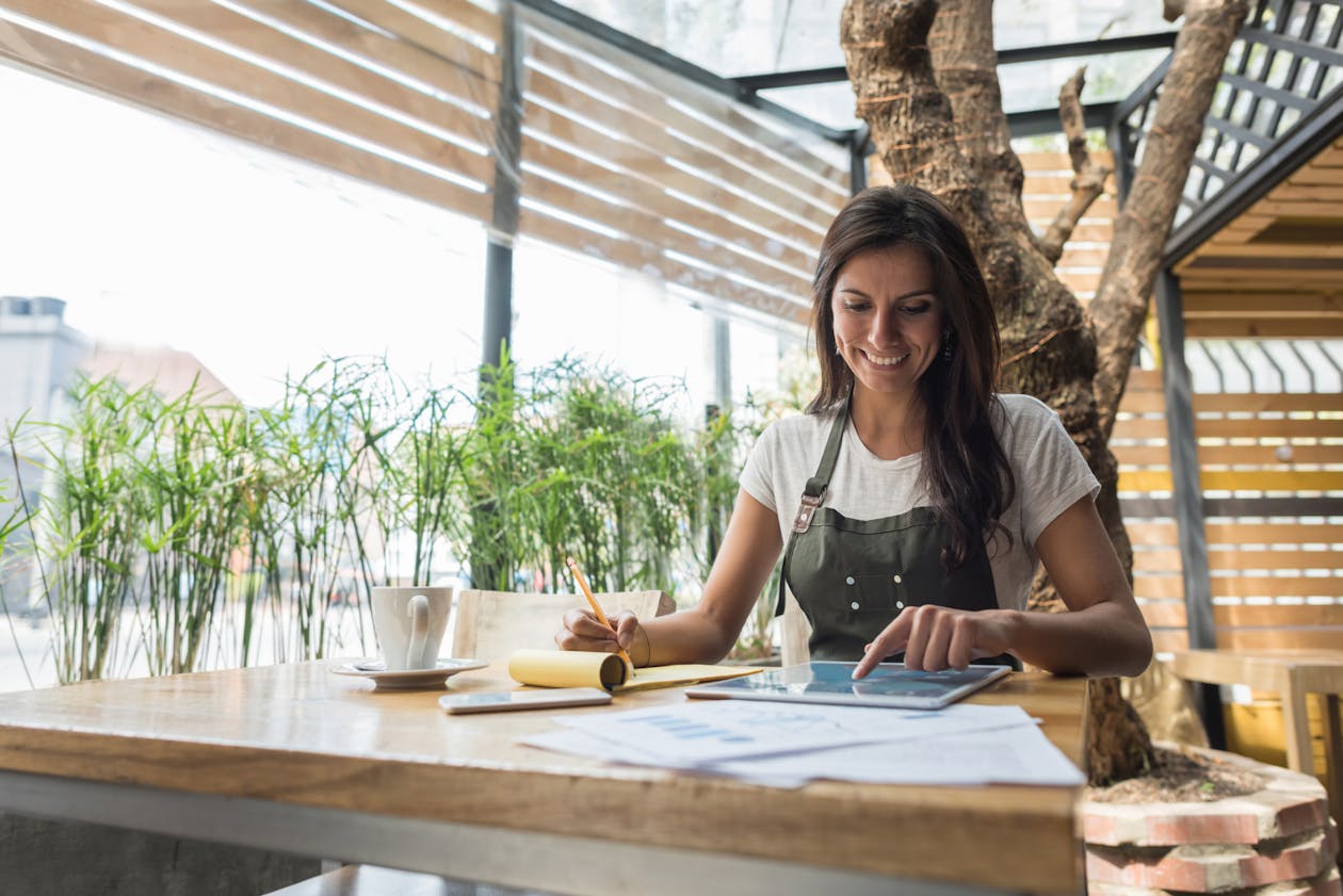 a woman sitting at a table in front of a window