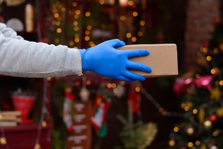 A person handing over a package during the holidays