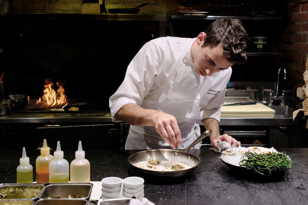 a man cooking in a kitchen preparing food