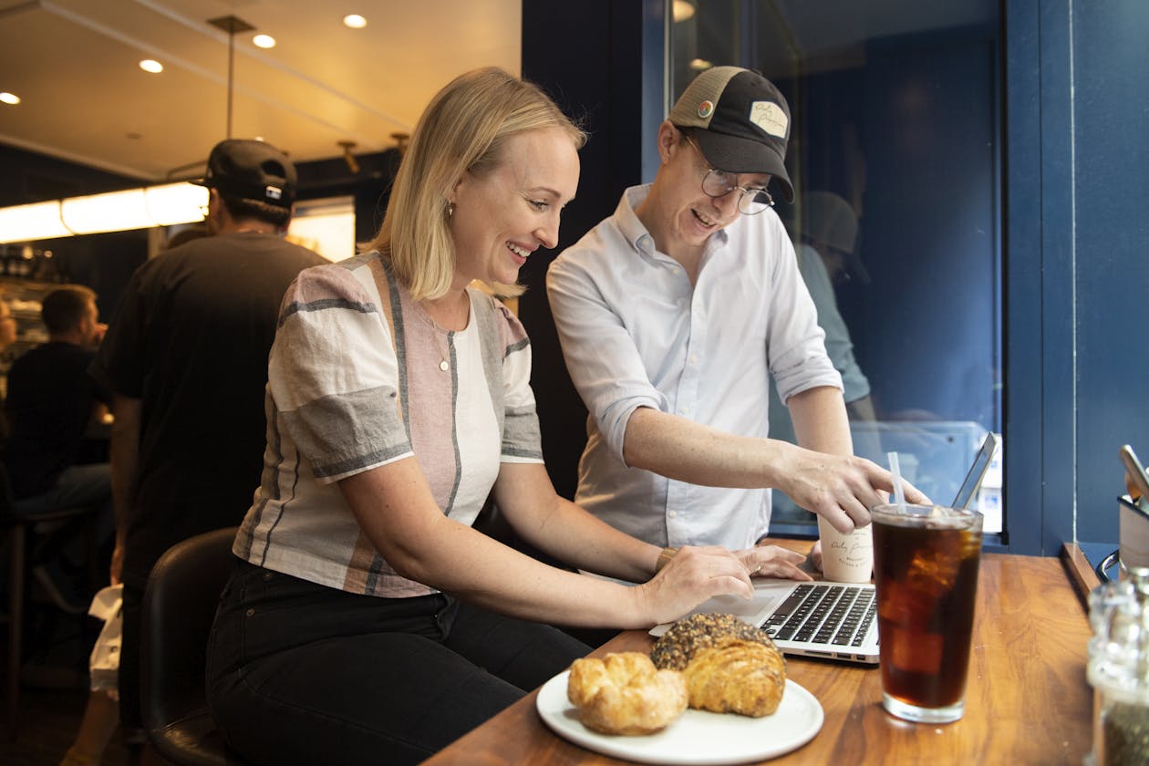 a woman sitting at a table with food