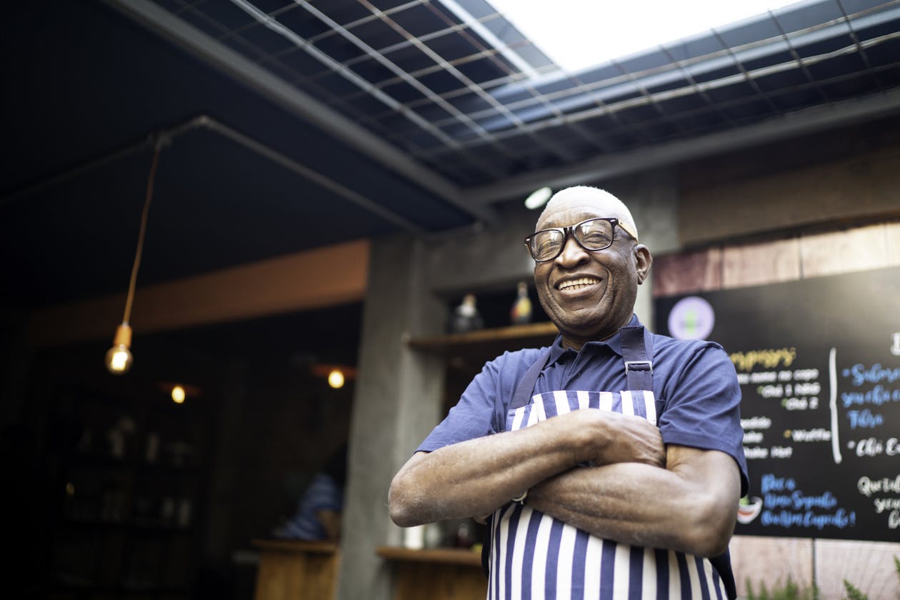a restaurant owner standing in a restaurant.