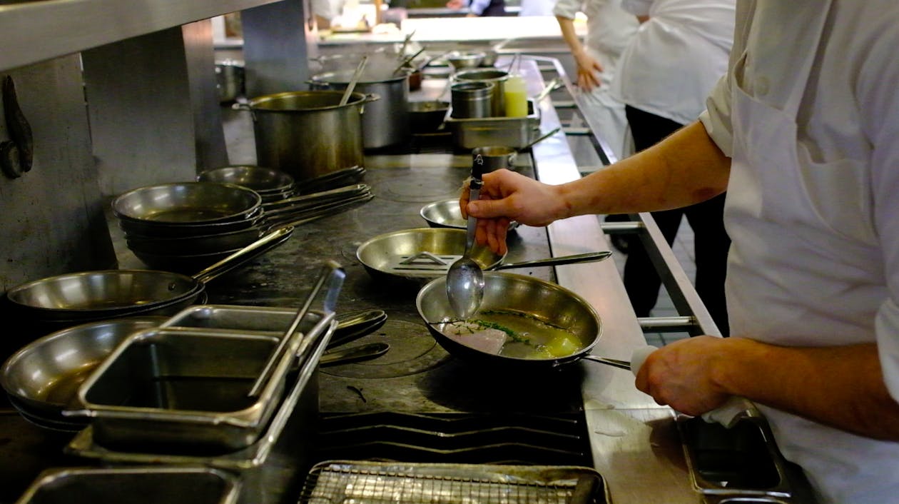 a man cooking in a kitchen preparing food