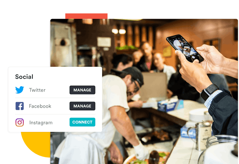 A person taking a photo at a pizza restaurant