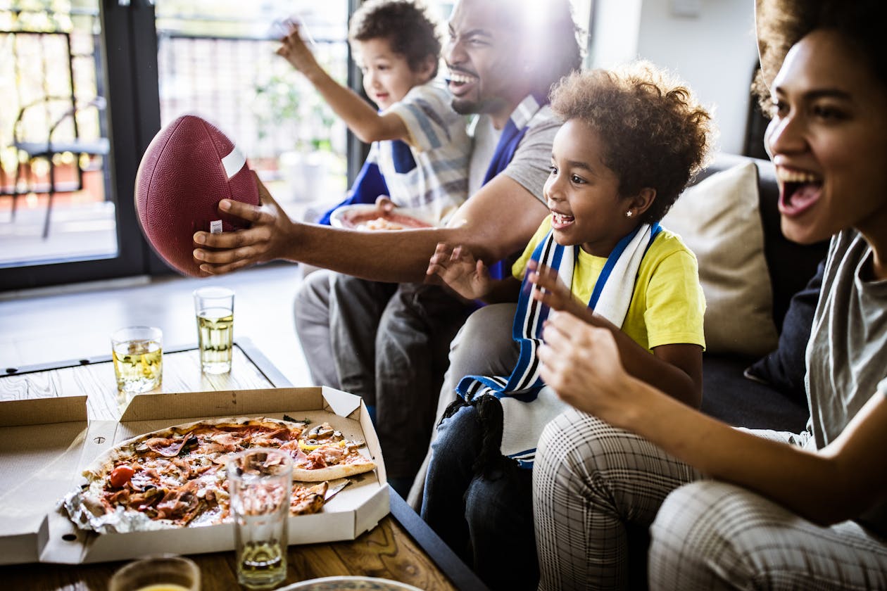 a group of people sitting at a table eating food