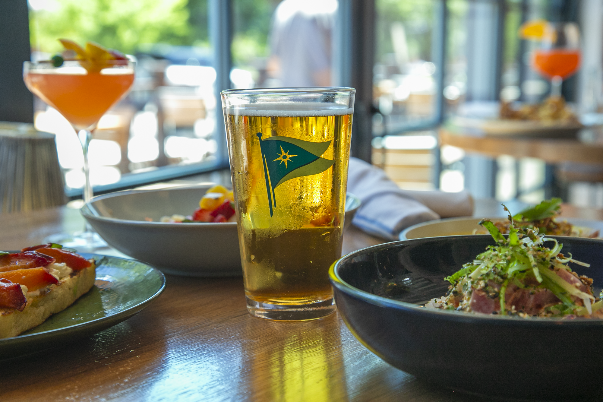 a glass of beer and food on a table