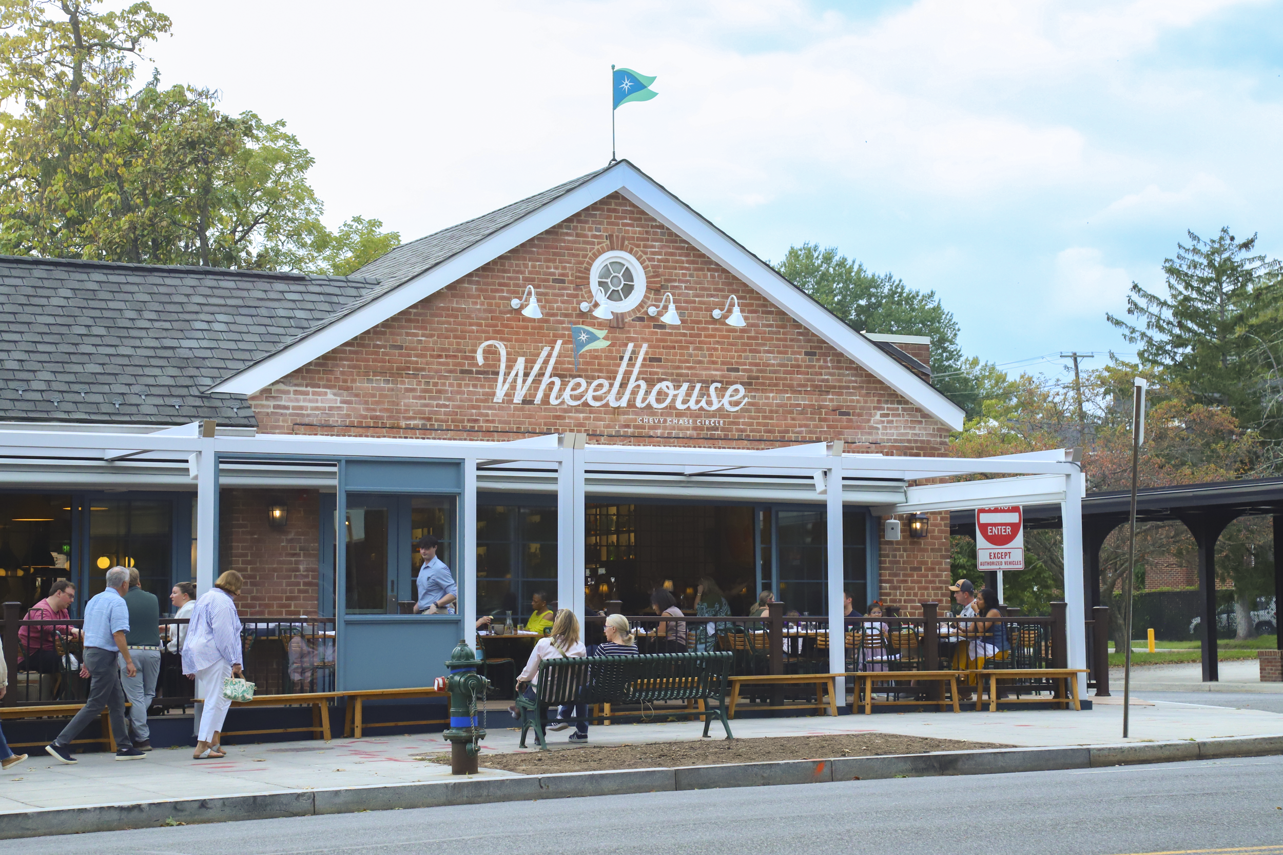 a brick building with people sitting outside