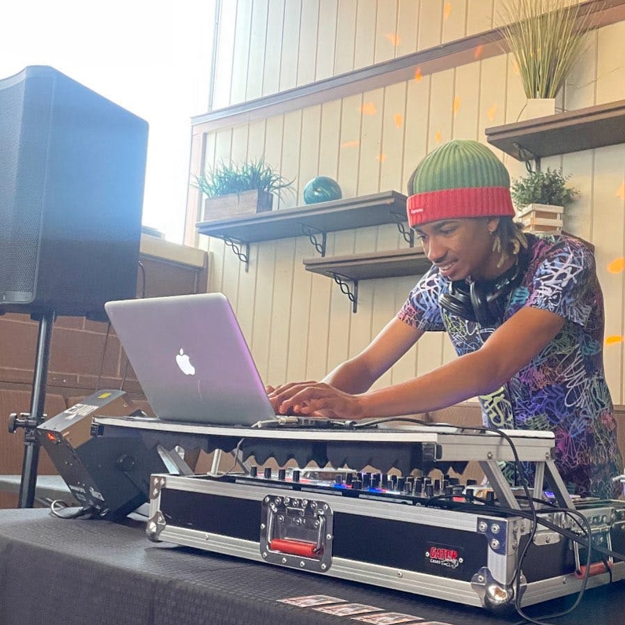 a boy standing in front of a computer