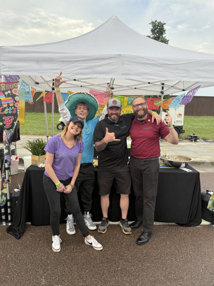 a group of people standing in front of a tent