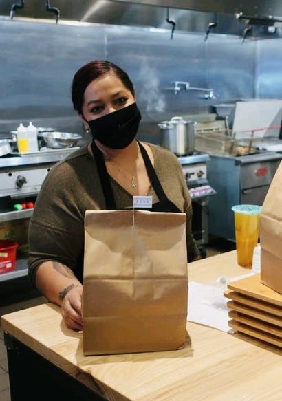 a person sitting at a table in front of a box