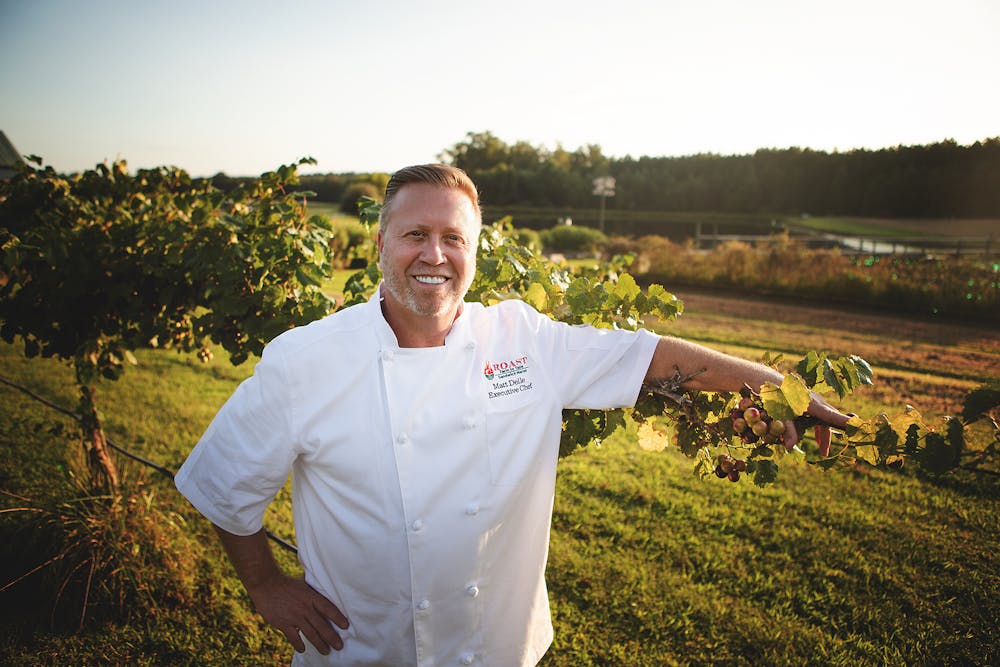 a man standing in a field posing for the camera