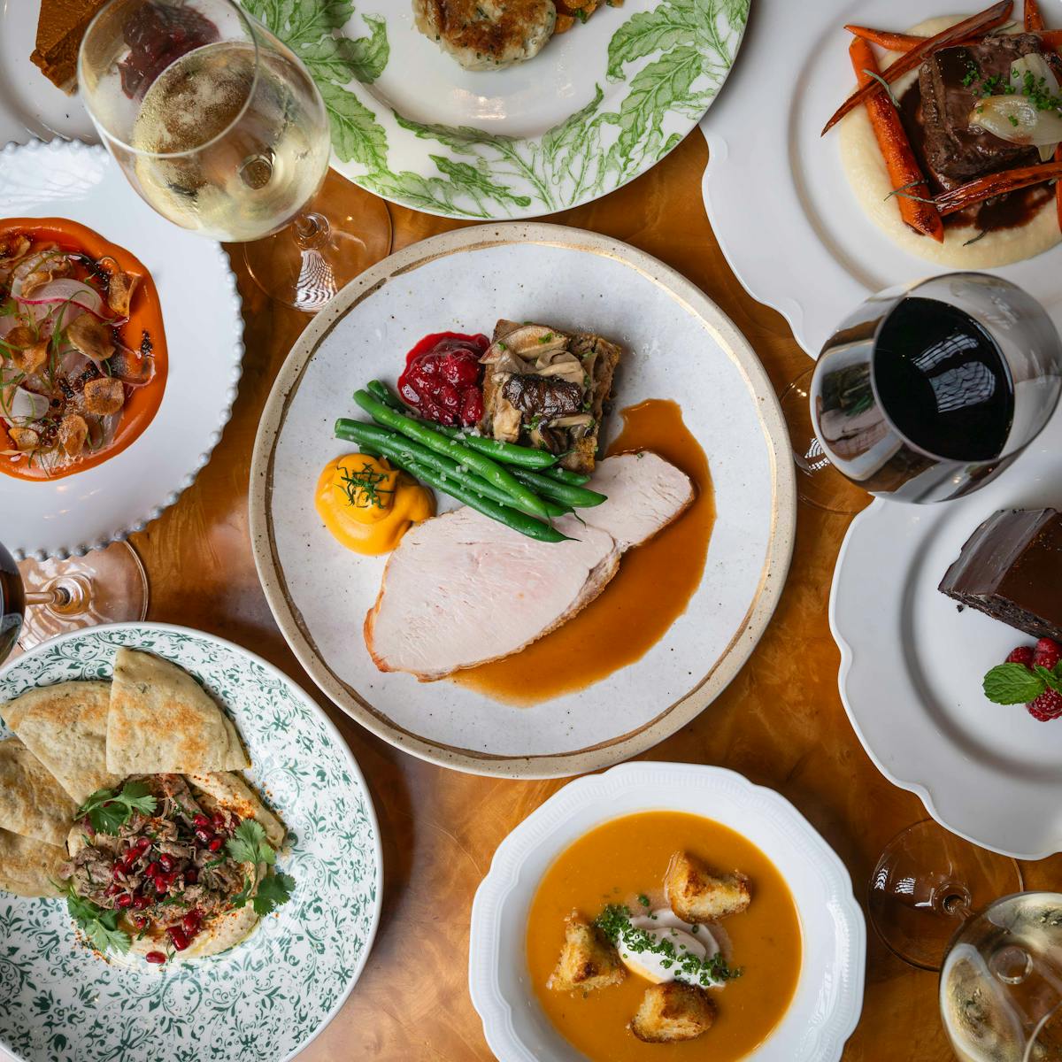 a group of people sitting at a table with a plate of food