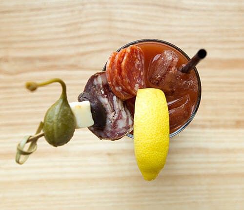a glass of juice on a wooden table