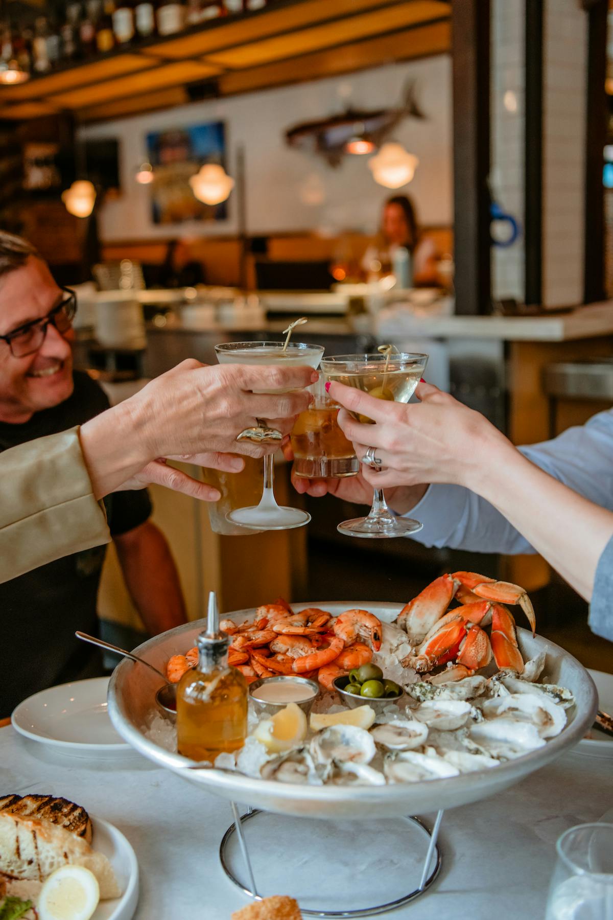 cheers with a large crowd to fresh oysters, crab, and shrimp with our seafood platters and martinis