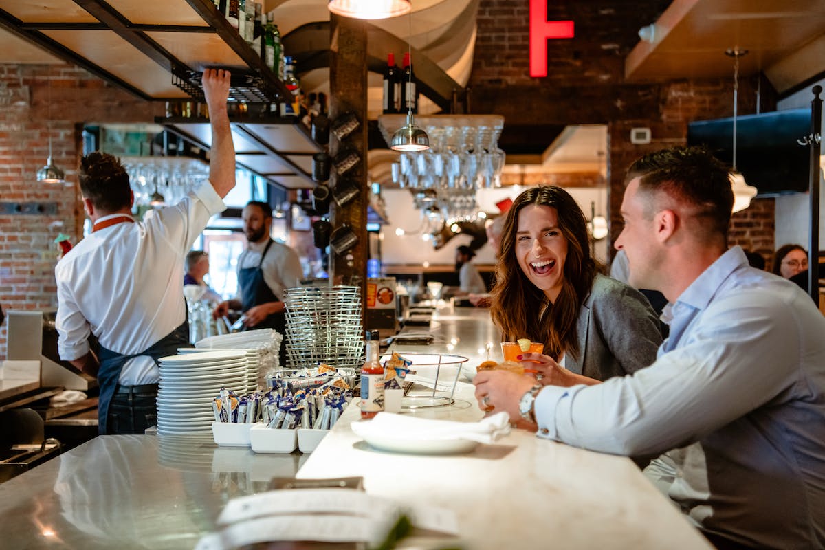a group of people sitting at a table eating food