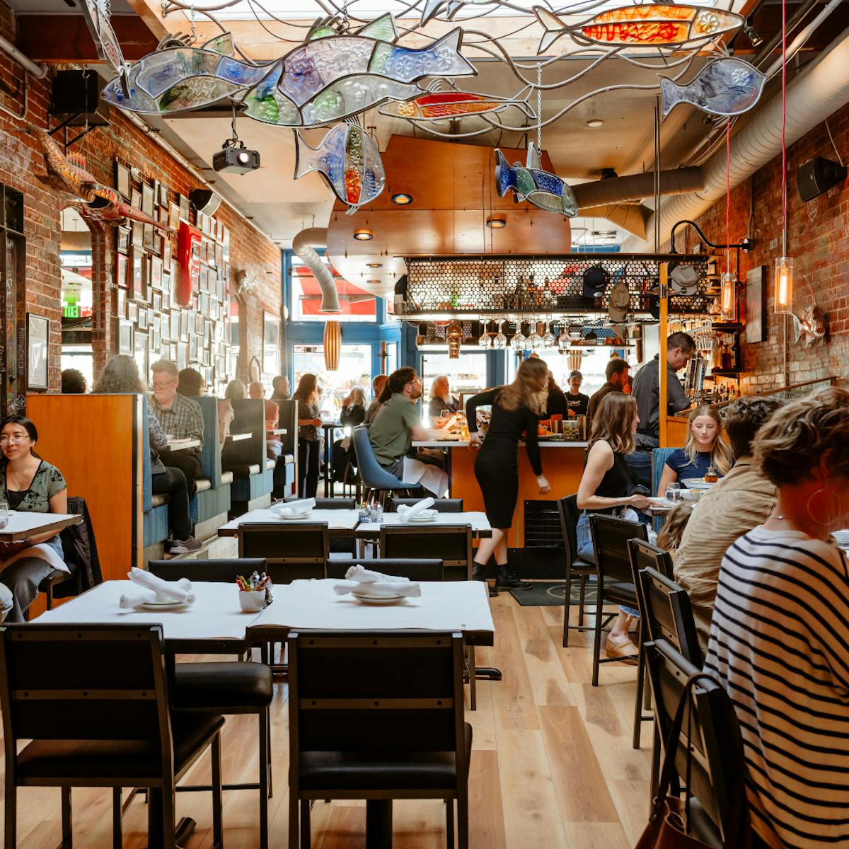 a group of people sitting at a table in a restaurant