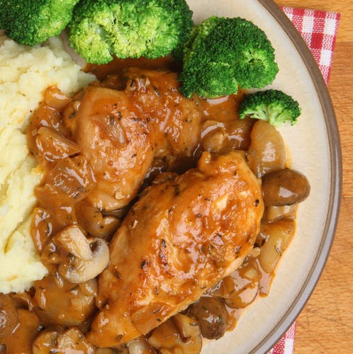 a plate of food with rice meat and broccoli