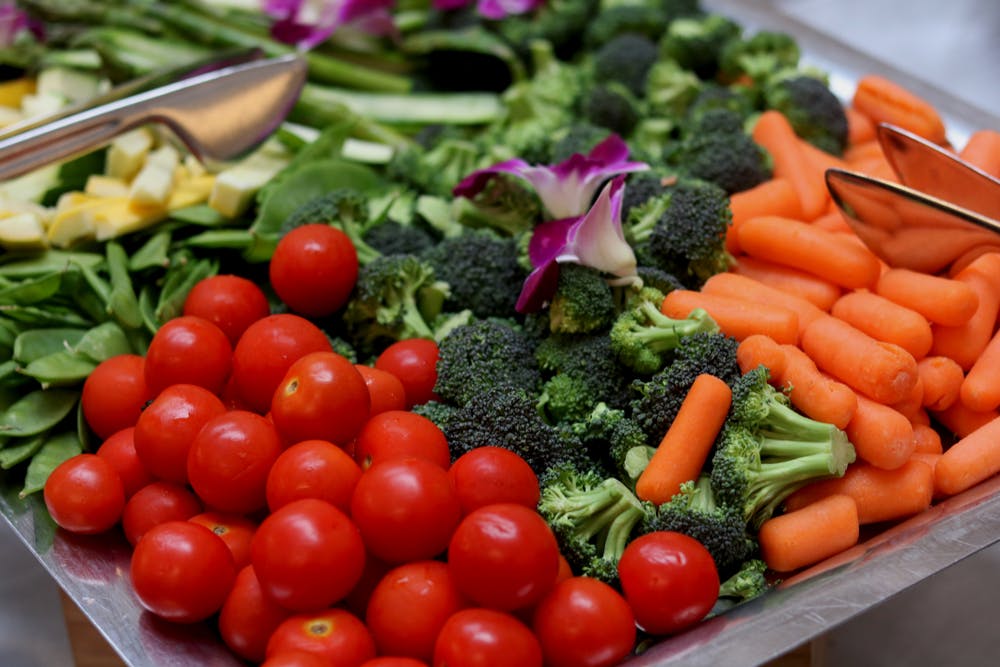 a bowl of fresh vegetables on a table