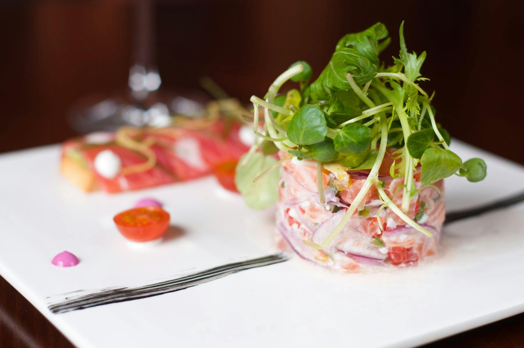 a plate of food with a salad on top