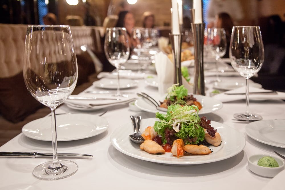a white plate topped with glasses of wine on a table
