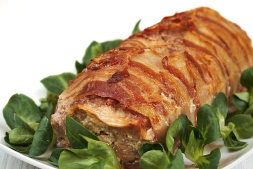 a close up of a white plate topped with a sandwich and a salad