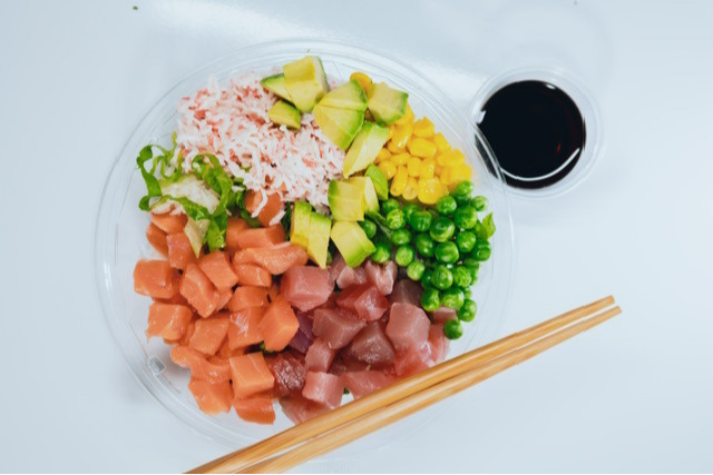 a close up of a plate of food with a sandwich and a salad