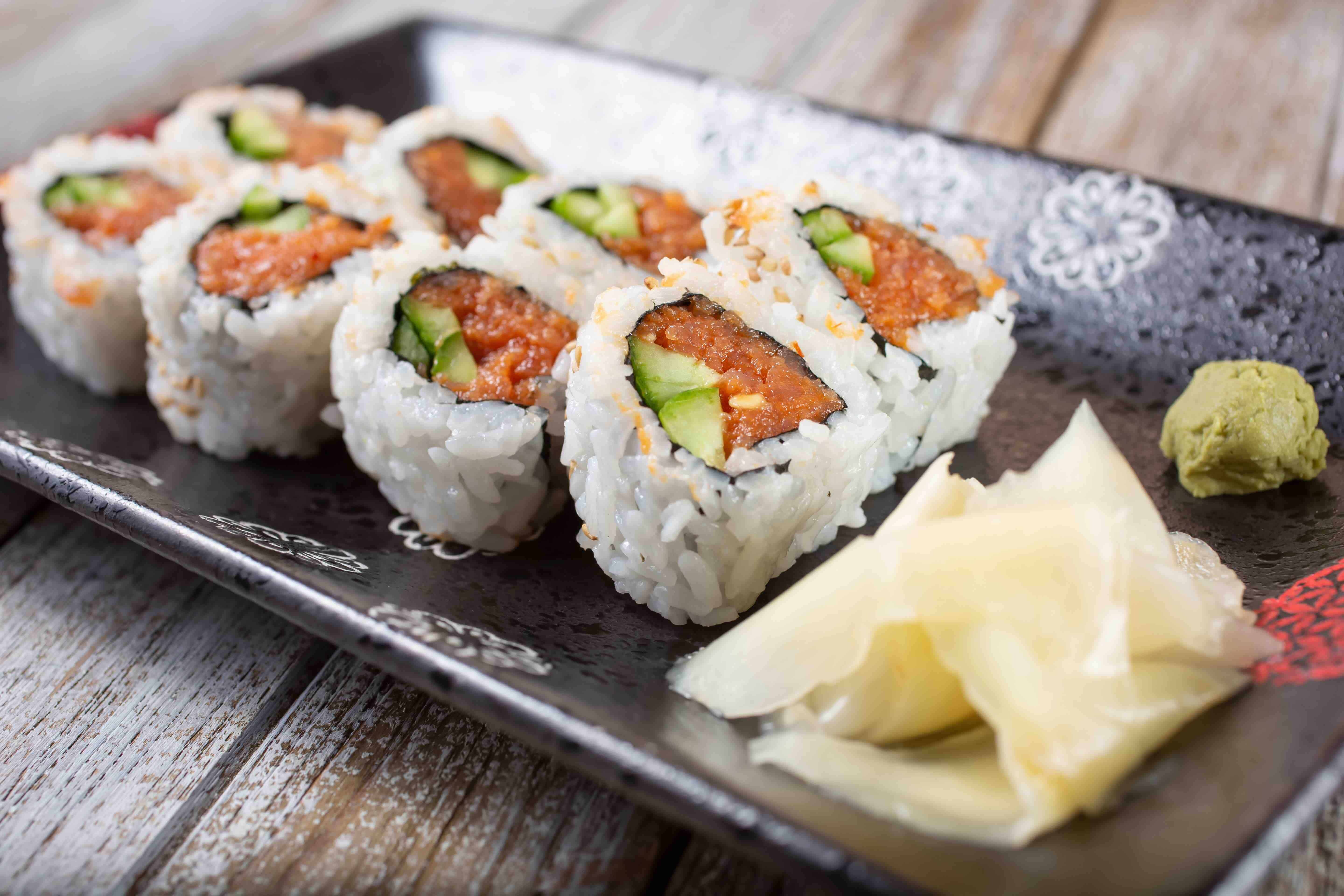 a close up of sushi on a wooden table