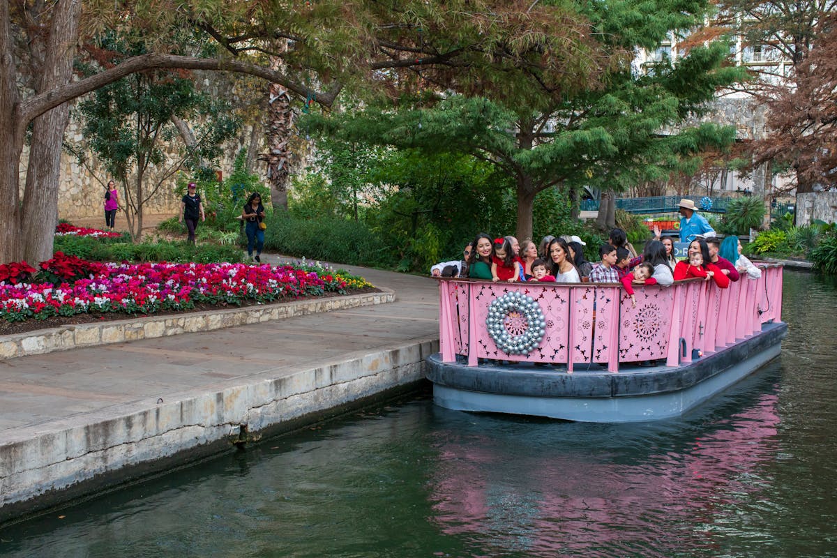 a group of people in a small boat in a body of water