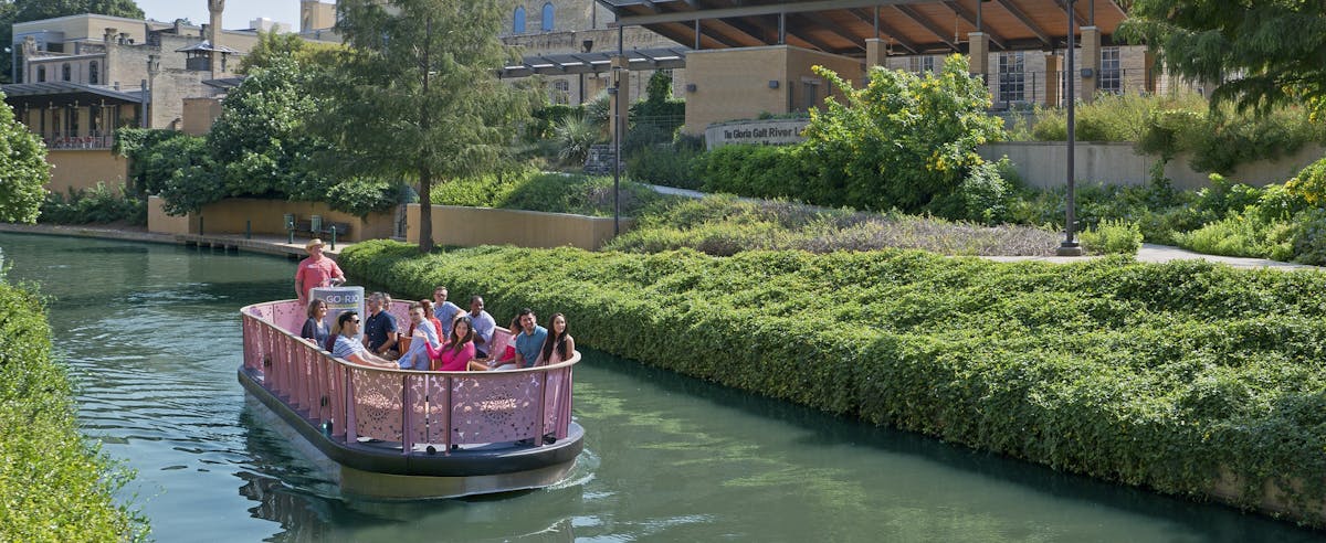 a group of people in a small boat in a river