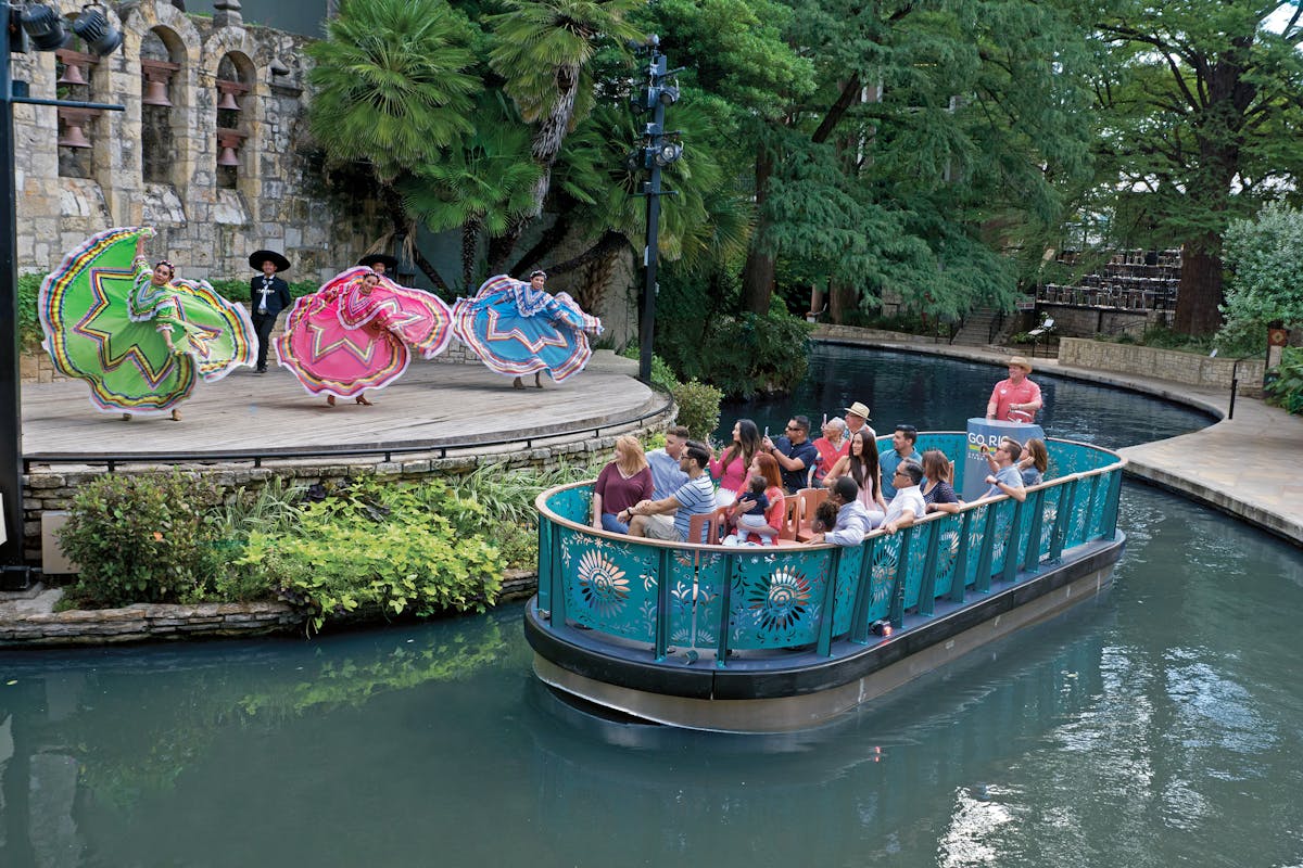 a group of people in a boat on a river