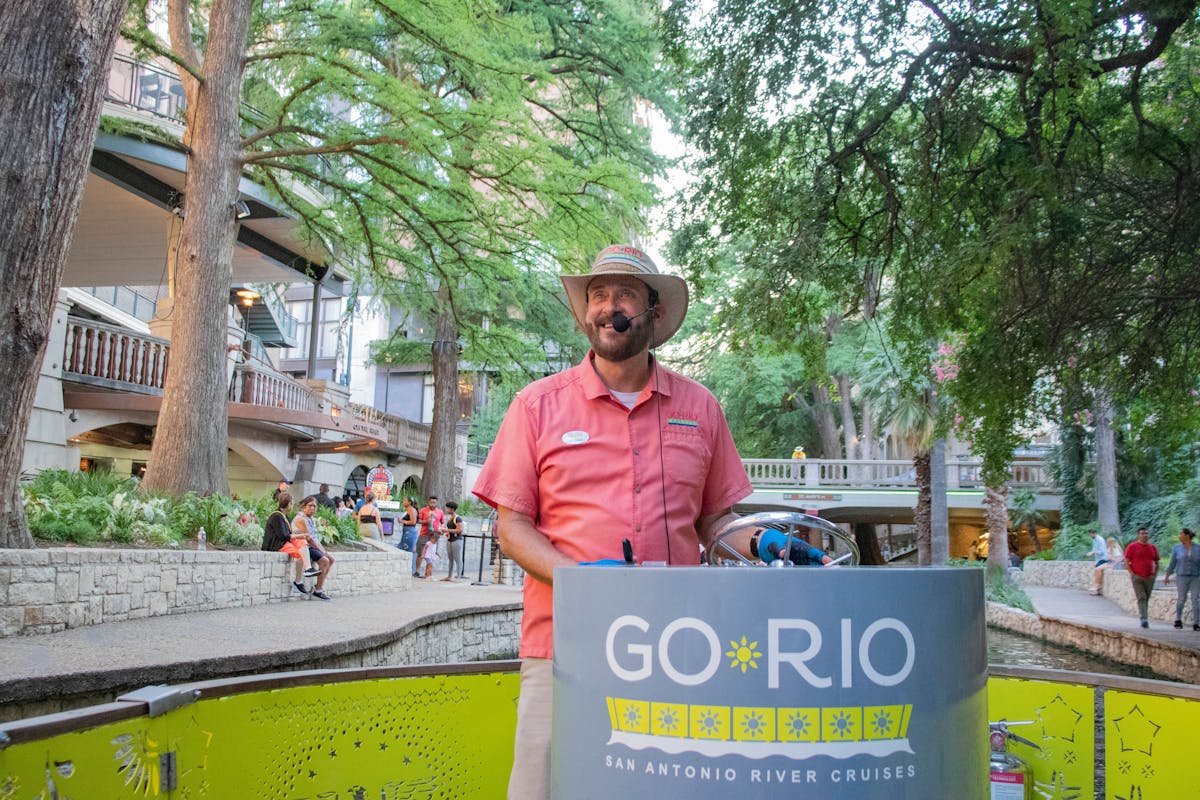 a person sitting at a table in front of a tree