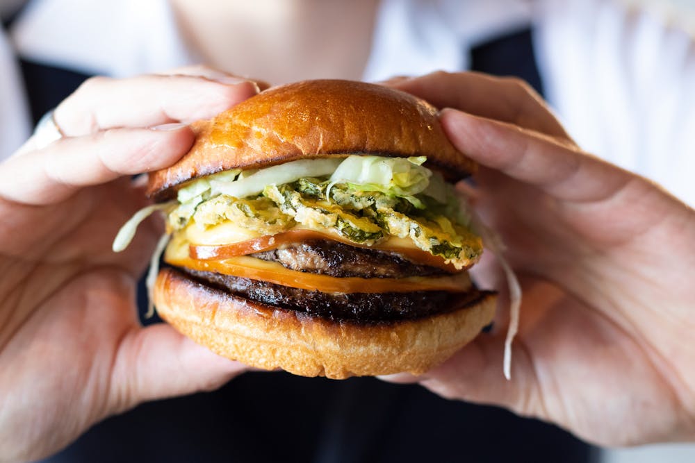 a hand holding a sandwich