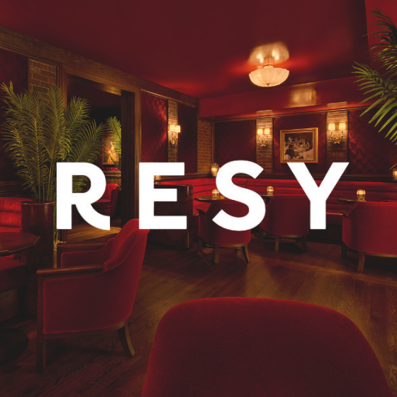 a room with red chairs and a lamp