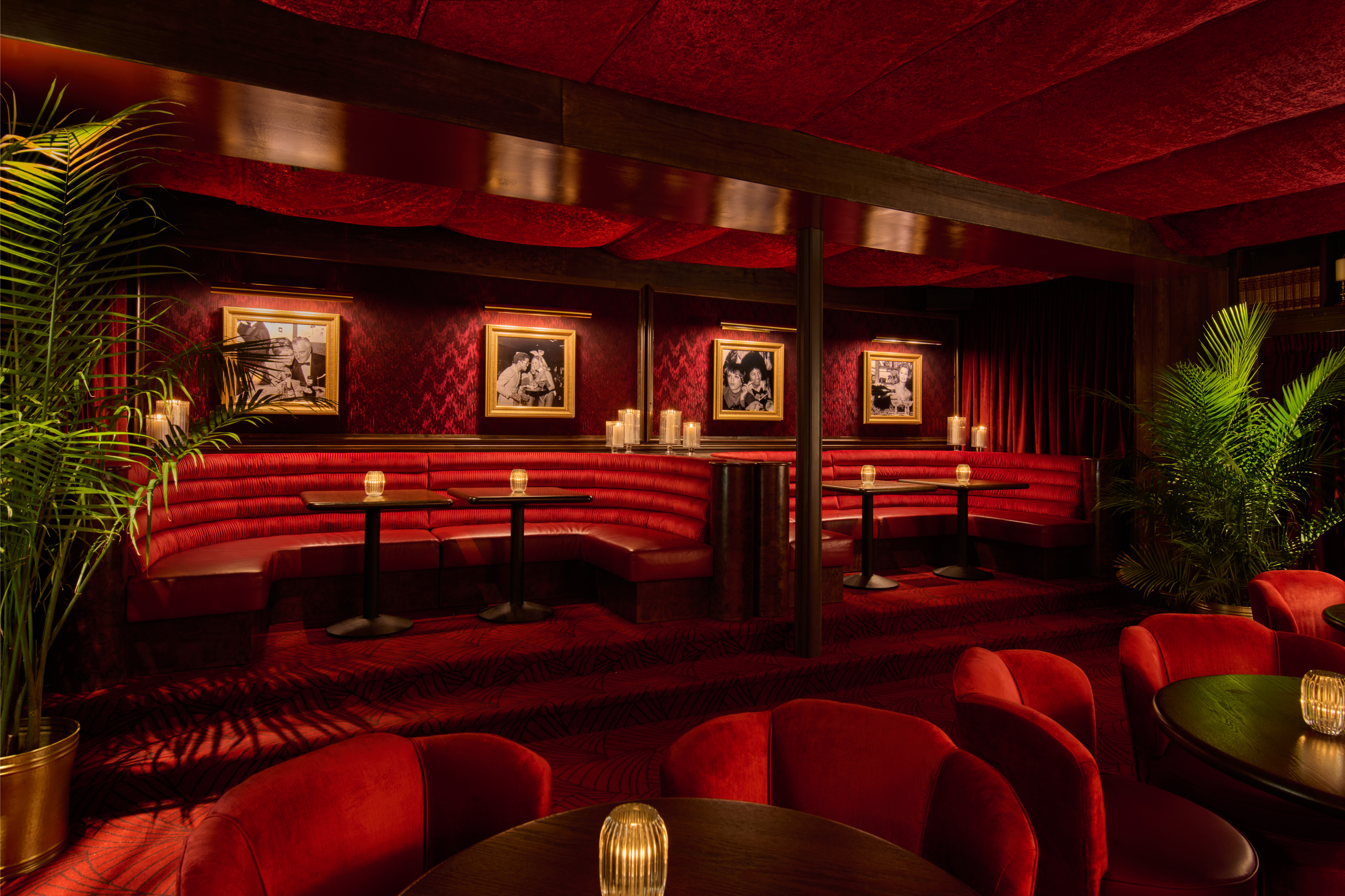 a room with red couches and tables