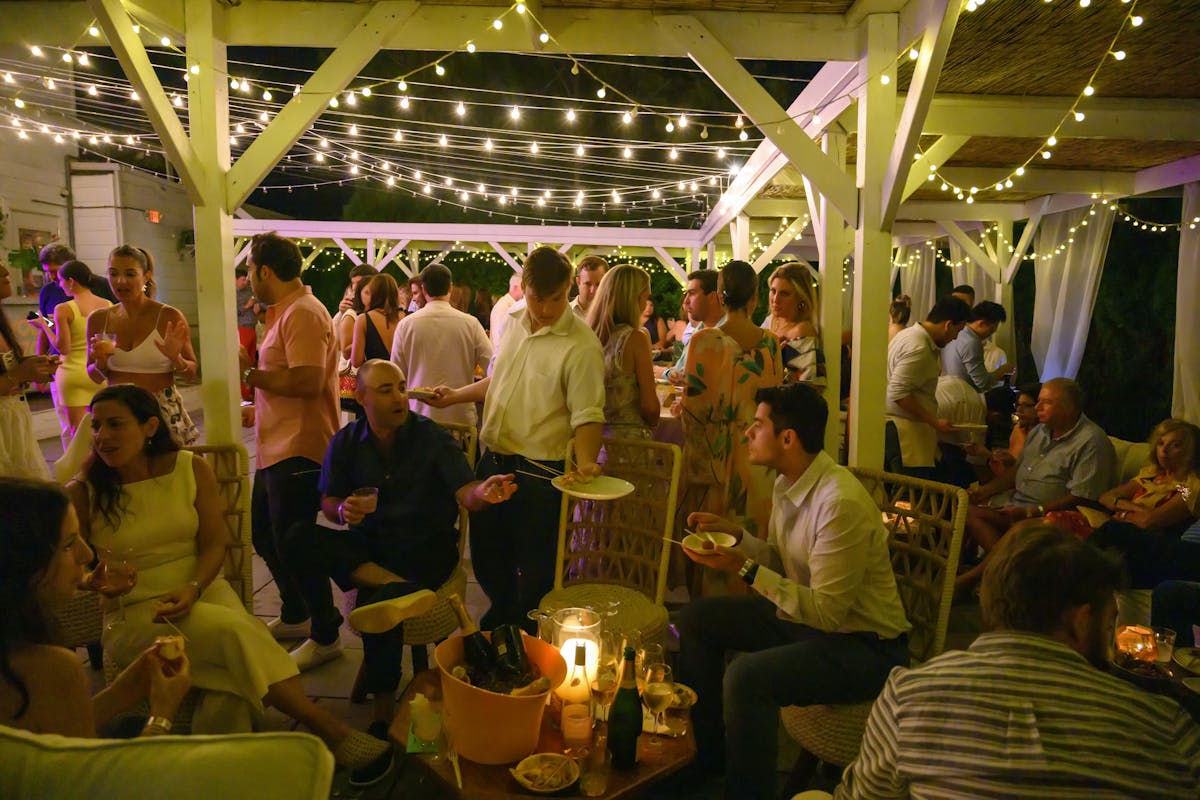 people in a dining tent area