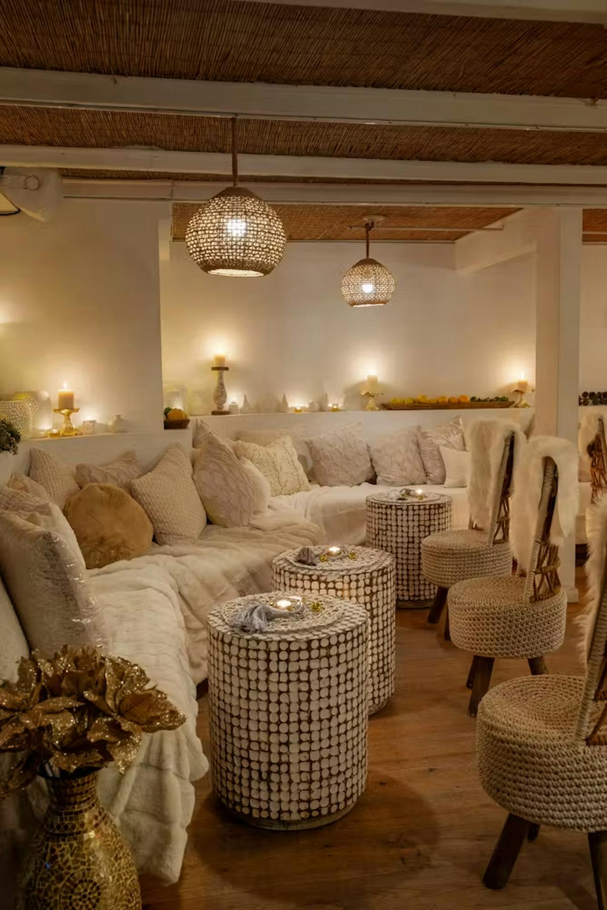a living room filled with furniture and vase of flowers on a table