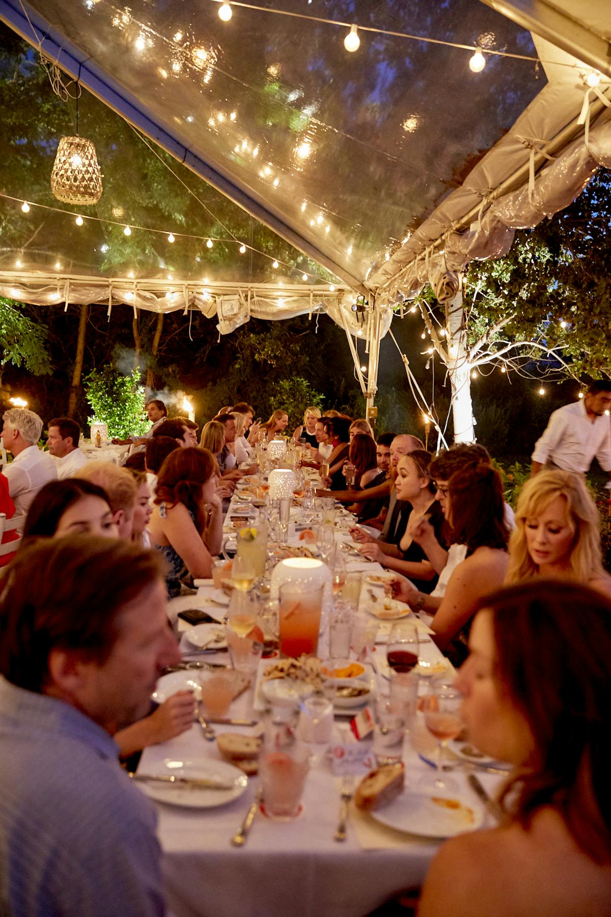 a group of people sitting at a table with wine glasses