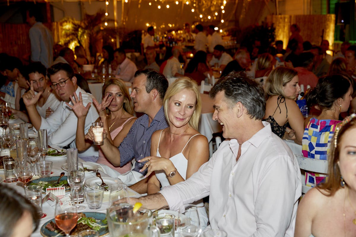 a group of people sitting at a dinner table
