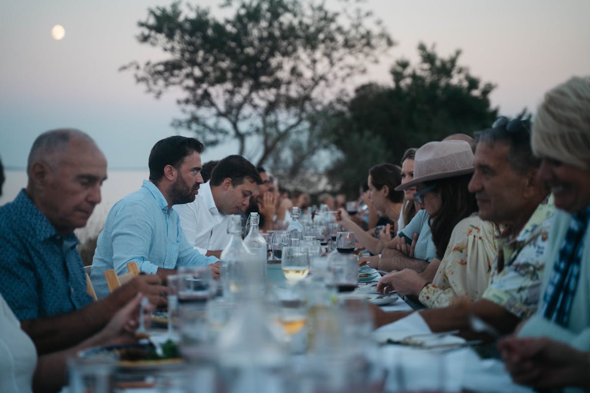 a group of people standing around a table